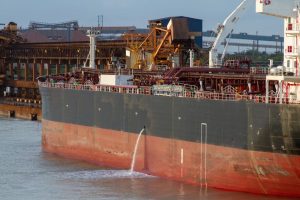 A photograph of a ship taking part in de-ballasting.